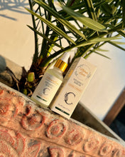 Vitamin C serum bottle and box on a stone surface with green leaves in the background